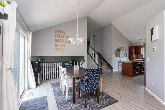 413 W Cook St, Manteno, IL 60950 - dining area with a chandelier, lofted ceiling, light wood-style flooring, baseboards, and a ceiling fan