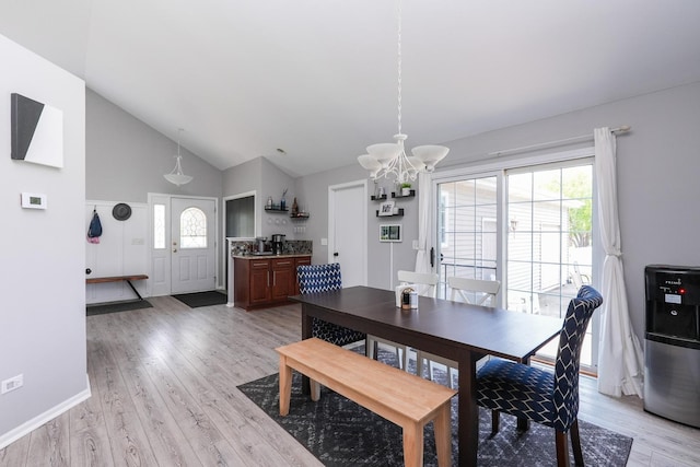 413 W Cook St, Manteno, IL 60950 - dining room with a chandelier, light wood-type flooring, healthy amount of natural light, high vaulted ceiling, and baseboards