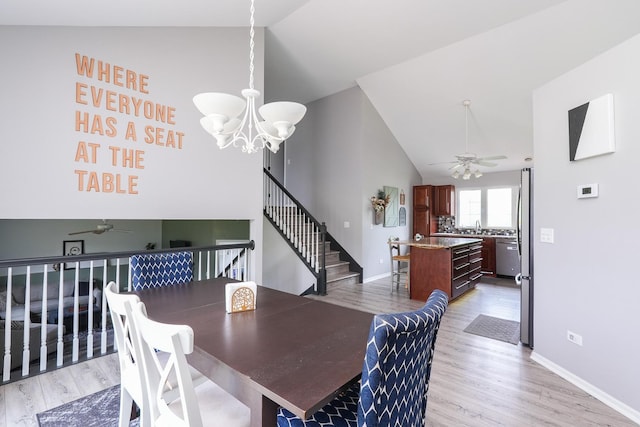 413 W Cook St, Manteno, IL 60950 - dining room with lofted ceiling, a ceiling fan, a chandelier, light wood finished floors, and stairway