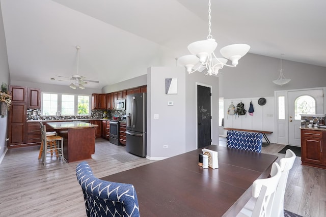 413 W Cook St, Manteno, IL 60950 - dining room with high vaulted ceiling, a chandelier, light wood-type flooring, and ceiling fan