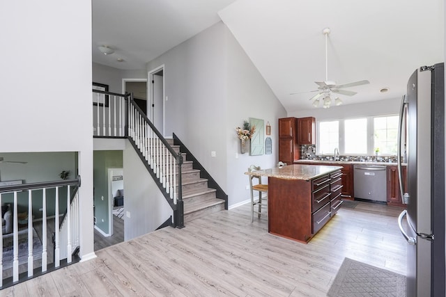 413 W Cook St, Manteno, IL 60950 - kitchen with stainless steel appliances, a sink, a center island, light wood-type flooring, and ceiling fan
