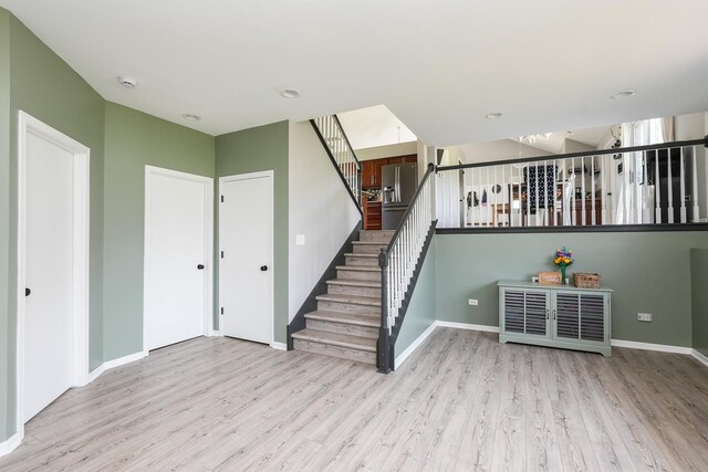 413 W Cook St, Manteno, IL 60950 - unfurnished living room with wood finished floors, stairway, and baseboards