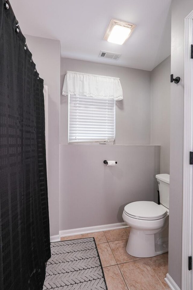 413 W Cook St, Manteno, IL 60950 - bathroom with toilet, tile patterned floors, baseboards, and curtained shower