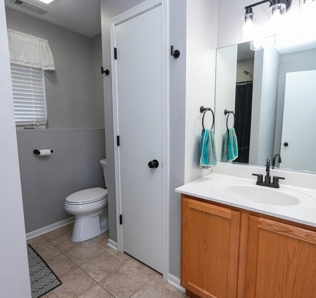 413 W Cook St, Manteno, IL 60950 - bathroom with vanity, toilet, tile patterned floors, and baseboards