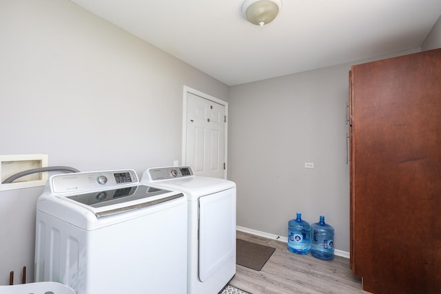 413 W Cook St, Manteno, IL 60950 - laundry room with washing machine and dryer, light wood-style flooring, and baseboards