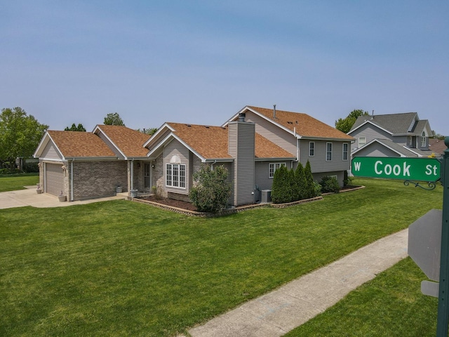 413 W Cook St, Manteno, IL 60950 - view of front of house with an attached garage, a front yard, concrete driveway, and roof with shingles