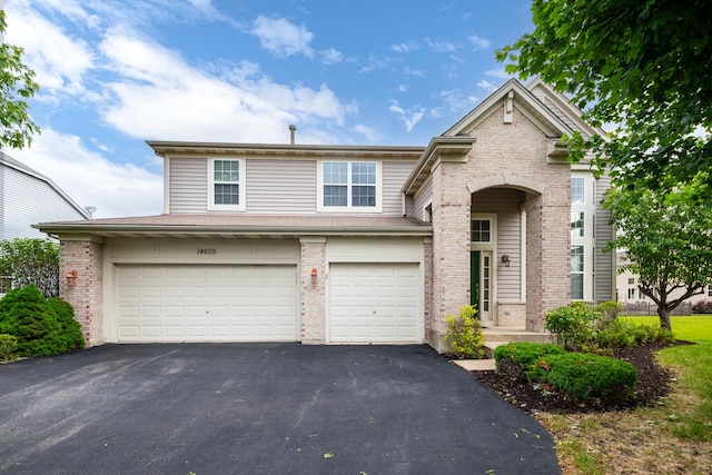 14605 Colonial Pkwy, Plainfield, IL 60544 - traditional-style house with driveway, a garage, and brick siding
