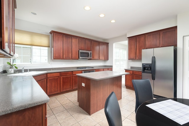 14605 Colonial Pkwy, Plainfield, IL 60544 - kitchen with appliances with stainless steel finishes, a sink, light tile patterned floors, a center island, and recessed lighting