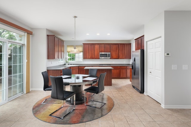 14605 Colonial Pkwy, Plainfield, IL 60544 - kitchen with appliances with stainless steel finishes, light tile patterned flooring, a kitchen island, baseboards, and recessed lighting