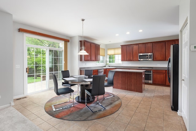 14605 Colonial Pkwy, Plainfield, IL 60544 - kitchen with appliances with stainless steel finishes, a center island, recessed lighting, light tile patterned floors, and baseboards