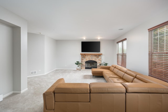14605 Colonial Pkwy, Plainfield, IL 60544 - living area featuring light carpet, baseboards, and a stone fireplace
