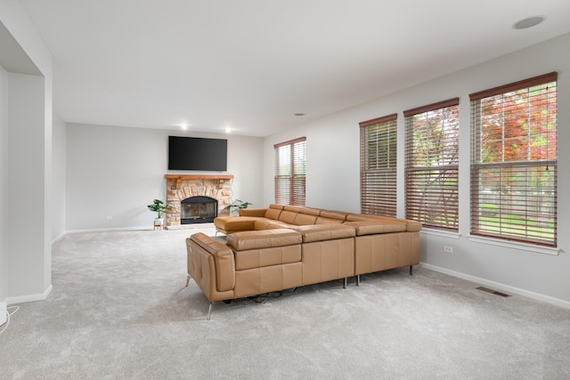 14605 Colonial Pkwy, Plainfield, IL 60544 - living room with carpet, a stone fireplace, and baseboards