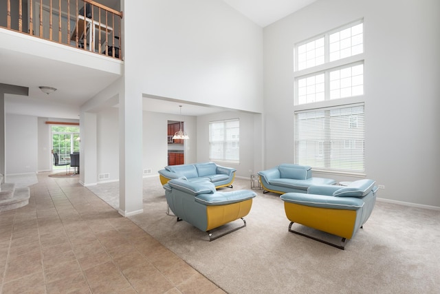 14605 Colonial Pkwy, Plainfield, IL 60544 - tiled living area with a towering ceiling and baseboards