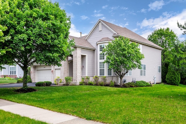 14605 Colonial Pkwy, Plainfield, IL 60544 - view of property hidden behind natural elements with a front lawn, asphalt driveway, and a garage