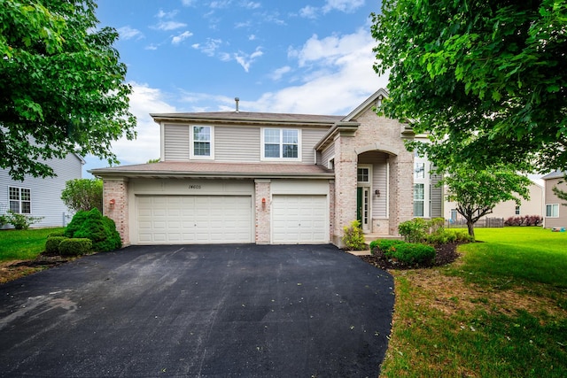 14605 Colonial Pkwy, Plainfield, IL 60544 - traditional home featuring asphalt driveway, brick siding, an attached garage, and a front yard