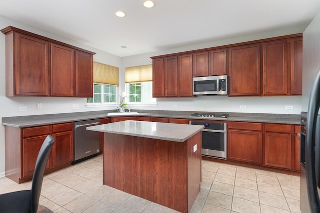 14605 Colonial Pkwy, Plainfield, IL 60544 - kitchen with appliances with stainless steel finishes, a sink, recessed lighting, a kitchen island, and light tile patterned floors