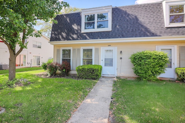 21 Fernwood Dr Unit 21U, Bolingbrook, IL 60440 - view of front of house featuring roof with shingles, a front yard, and cooling unit