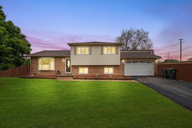8300 S 79th Ct, Justice, IL 60458 - split level home with asphalt driveway, a garage, brick siding, and a shingled roof