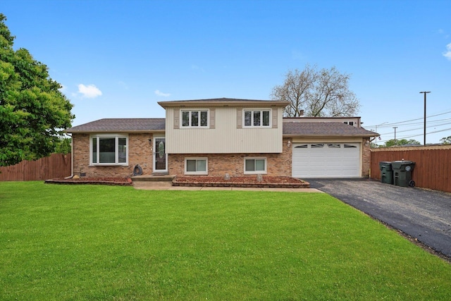 8300 S 79th Ct, Justice, IL 60458 - split level home with asphalt driveway, a garage, brick siding, and a shingled roof