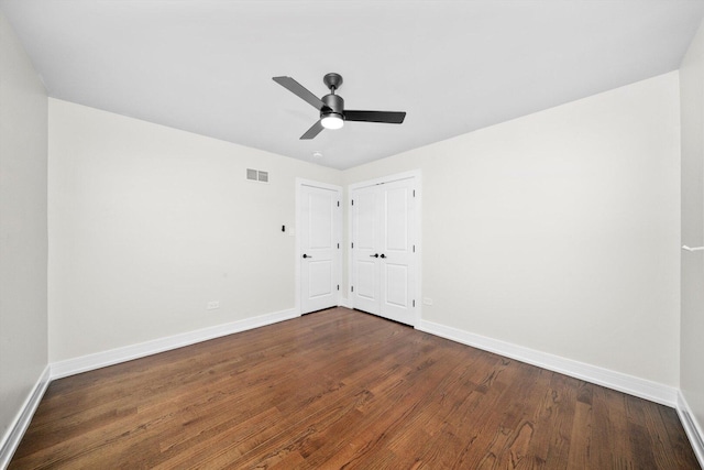 8300 S 79th Ct, Justice, IL 60458 - unfurnished bedroom with baseboards, dark wood-style flooring, a ceiling fan, and a closet
