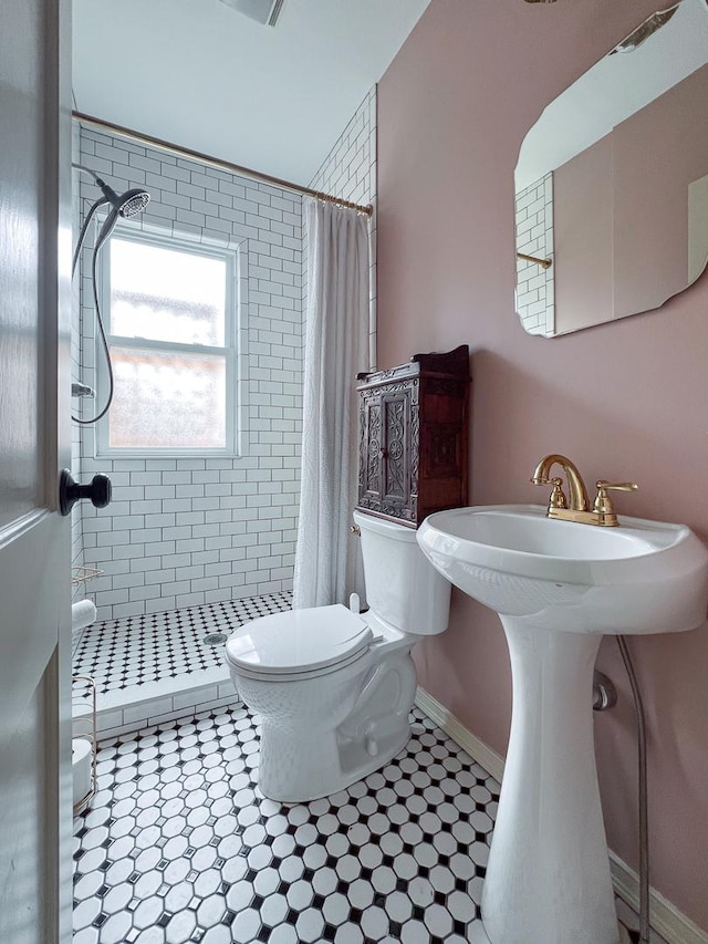 2013 E Taylor St, Bloomington, IL 61701 - full bathroom with toilet, a stall shower, baseboards, and tile patterned flooring