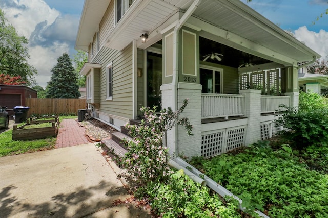 2013 E Taylor St, Bloomington, IL 61701 - view of side of home featuring a ceiling fan, a vegetable garden, and central AC