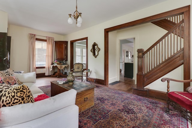 2013 E Taylor St, Bloomington, IL 61701 - living room featuring a chandelier, wood finished floors, baseboards, and stairs