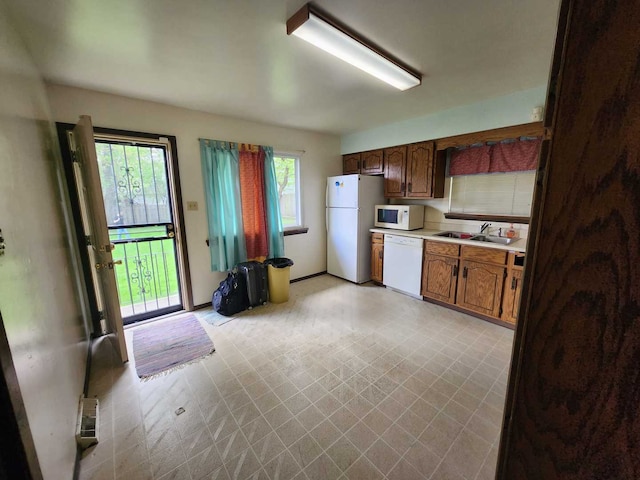 845 Muskegon Ave, Calumet City, IL 60409 - kitchen featuring white appliances, a sink, light countertops, and light floors