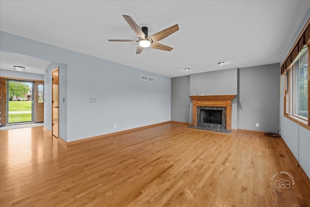 10N738 Prairie Xing, Elgin, IL 60124 - unfurnished living room featuring light wood-type flooring, a fireplace, ceiling fan, and baseboards