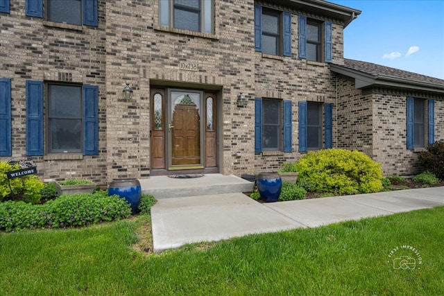 10N738 Prairie Xing, Elgin, IL 60124 - doorway to property featuring brick siding and a lawn