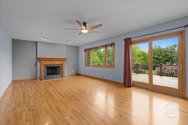 10N738 Prairie Xing, Elgin, IL 60124 - unfurnished living room with a ceiling fan, light wood-style floors, a high end fireplace, and baseboards