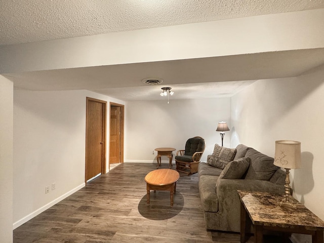 223 W Anderes Cir, Dalzell, IL 61320 - living area featuring dark wood-style flooring, baseboards, and a textured ceiling