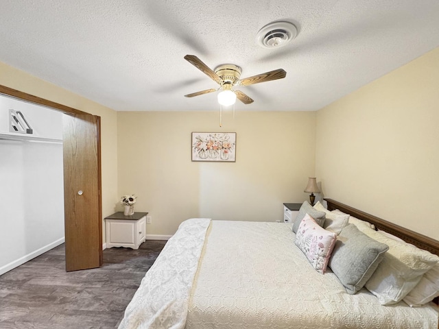 223 W Anderes Cir, Dalzell, IL 61320 - bedroom with dark wood-style floors, baseboards, a textured ceiling, a ceiling fan, and a closet