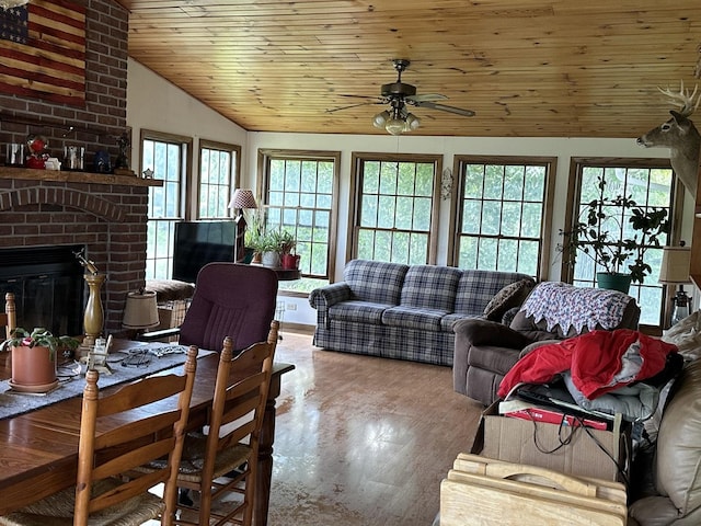 9669 Garden Plain Rd, Morrison, IL 61270 - living room with vaulted ceiling, a ceiling fan, wooden ceiling, wood finished floors, and a brick fireplace
