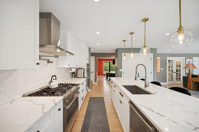 490 S Waukegan Rd, Lake Forest, IL 60045 - kitchen featuring wall chimney range hood, a sink, stainless steel appliances, backsplash, and french doors