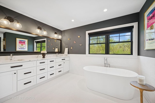 490 S Waukegan Rd, Lake Forest, IL 60045 - bathroom featuring double vanity, a wainscoted wall, a soaking tub, tile walls, and recessed lighting