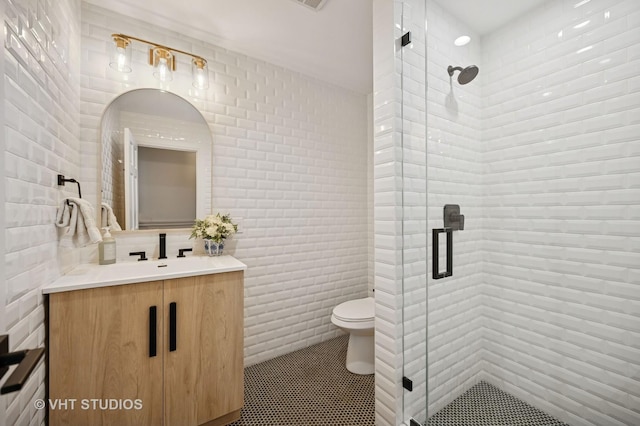 490 S Waukegan Rd, Lake Forest, IL 60045 - bathroom featuring vanity, tile walls, a shower stall, toilet, and tile patterned floors
