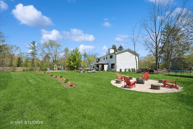 490 S Waukegan Rd, Lake Forest, IL 60045 - view of green lawn featuring a trampoline, a fire pit, and a playground