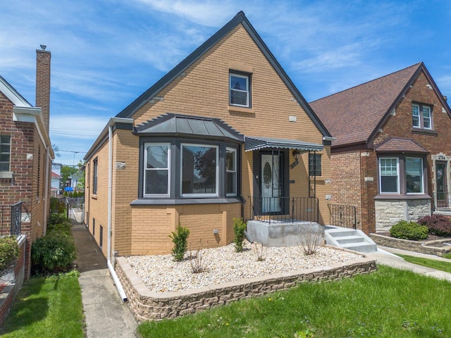 2702 N 76th Ave, Elmwood Park, IL 60707 - view of front of house with brick siding and a standing seam roof