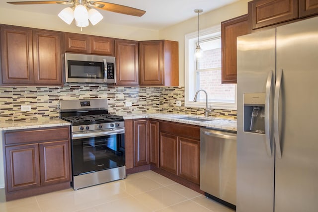 2702 N 76th Ave, Elmwood Park, IL 60707 - kitchen with stainless steel appliances, a sink, a ceiling fan, decorative backsplash, and light stone counters