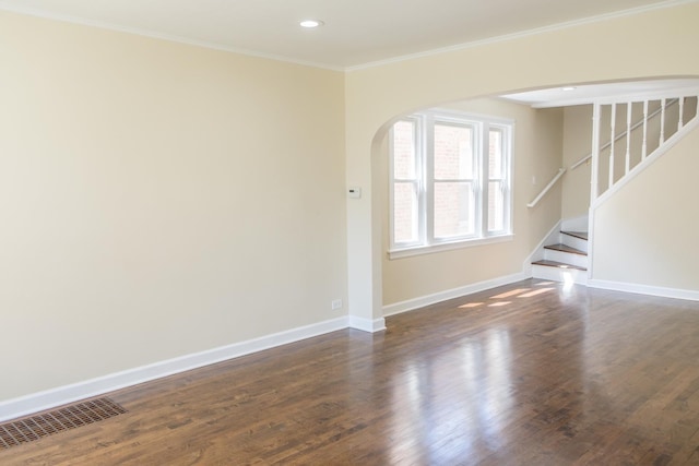 2702 N 76th Ave, Elmwood Park, IL 60707 - empty room with arched walkways, baseboards, dark wood-type flooring, ornamental molding, and stairs