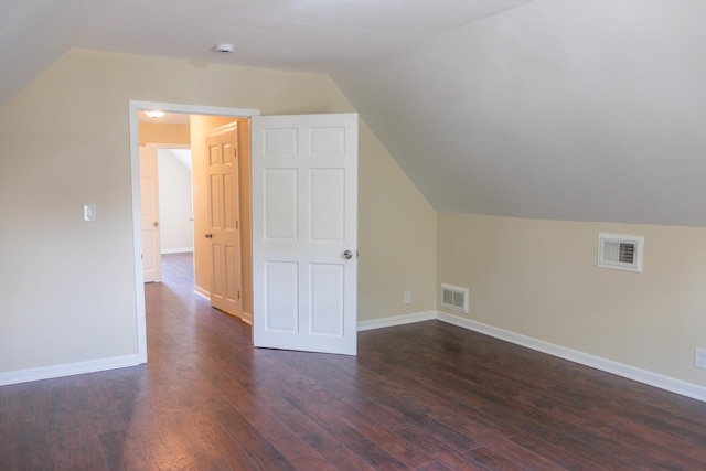 2702 N 76th Ave, Elmwood Park, IL 60707 - additional living space featuring vaulted ceiling, dark wood-type flooring, and baseboards