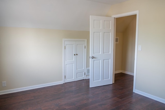 2702 N 76th Ave, Elmwood Park, IL 60707 - spare room with vaulted ceiling, dark wood-style floors, and baseboards