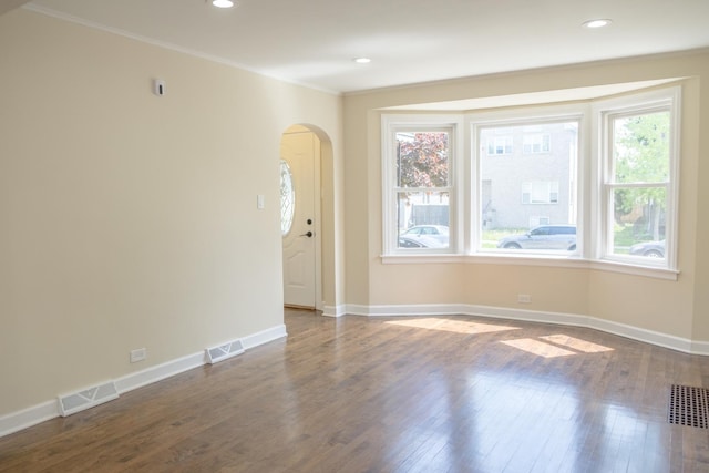 2702 N 76th Ave, Elmwood Park, IL 60707 - spare room featuring arched walkways, wood finished floors, baseboards, crown molding, and recessed lighting