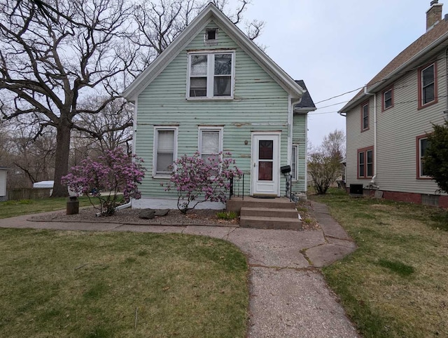 1215 3rd St, Moline, IL 61265 - view of front of house with a front yard and central air condition unit