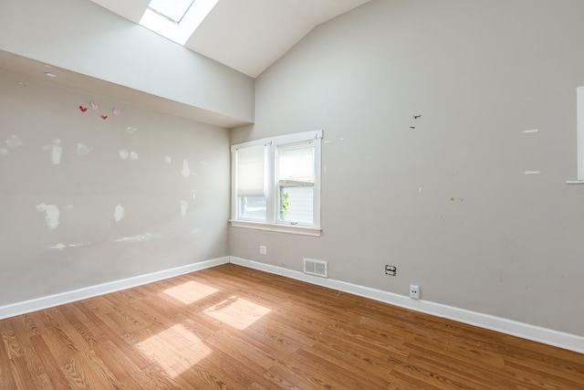 3924 W Greenleaf Ave, Lincolnwood, IL 60712 - unfurnished room with light wood-style floors, baseboards, a skylight, and high vaulted ceiling