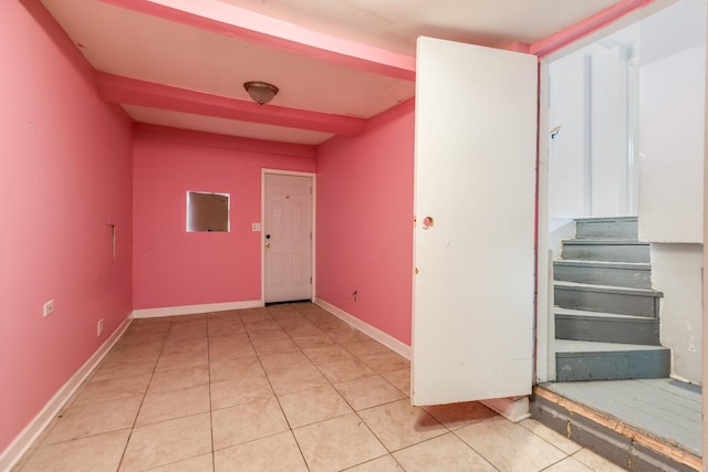 3924 W Greenleaf Ave, Lincolnwood, IL 60712 - spare room featuring baseboards, stairway, and light tile patterned flooring
