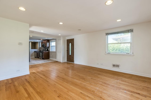 3924 W Greenleaf Ave, Lincolnwood, IL 60712 - unfurnished living room featuring light wood finished floors, baseboards, and recessed lighting
