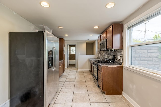 3924 W Greenleaf Ave, Lincolnwood, IL 60712 - kitchen featuring appliances with stainless steel finishes, baseboards, brown cabinetry, decorative backsplash, and recessed lighting