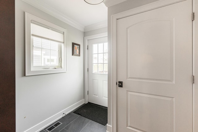732 S Mitchell Ave, Elmhurst, IL 60126 - doorway featuring baseboards, ornamental molding, and dark tile patterned floors